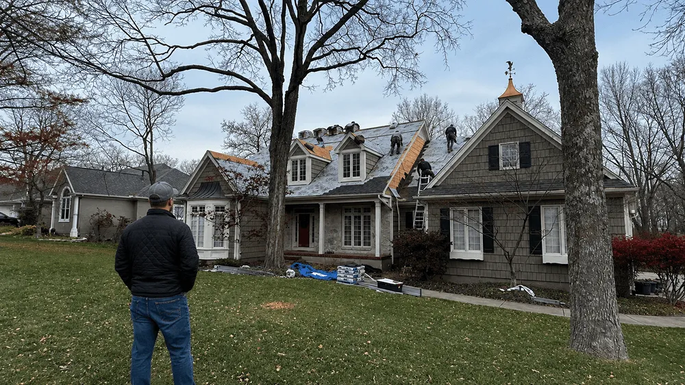 Homeowner looking at his roof replacement in Overland Park for his asphalt shingle roof